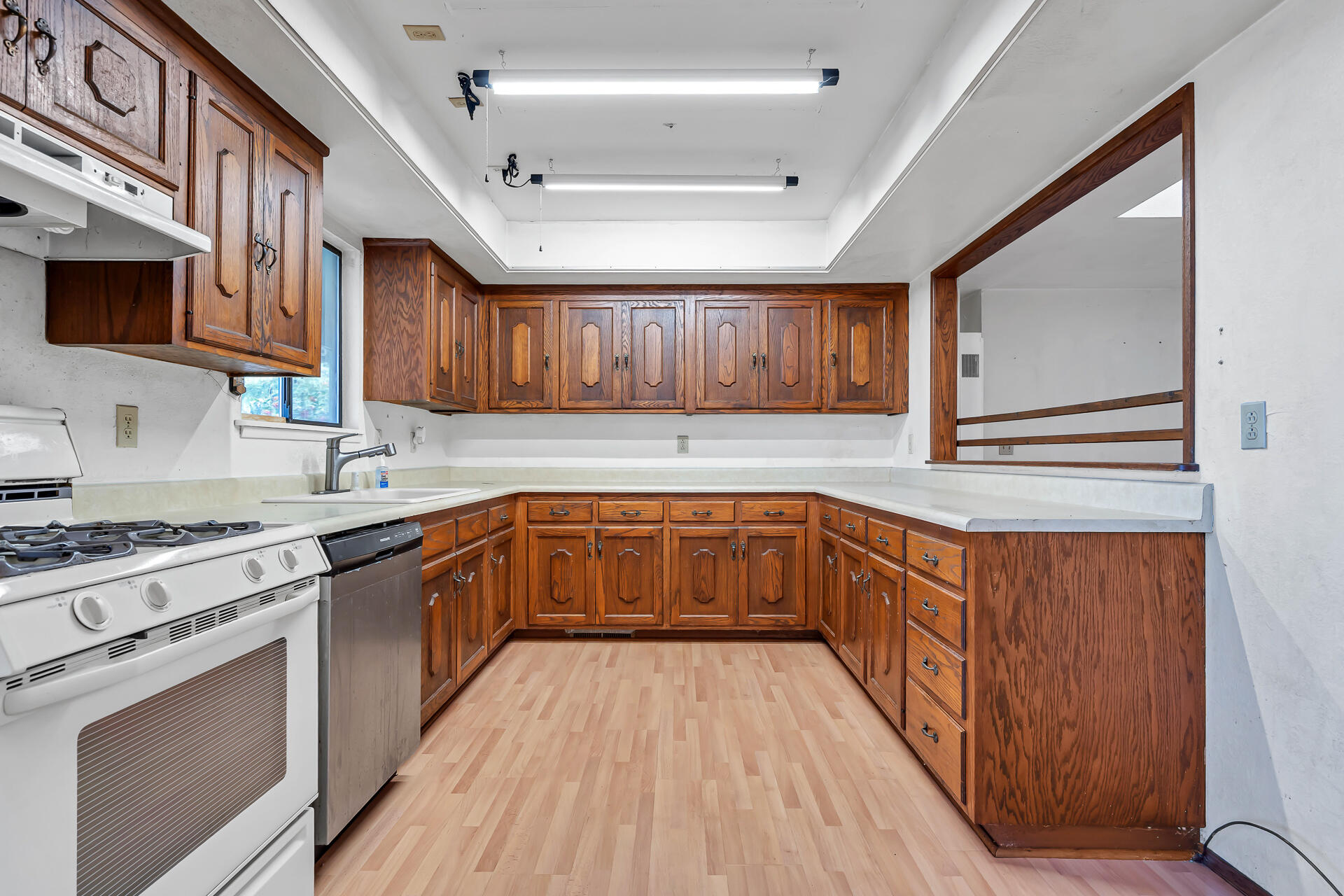 240 D Street Tehama, CA 96090 - Photo 6 of 41 a kitchen with stainless steel appliances granite countertop wooden cabinets a sink a stove a refrigerator and island with wooden floors