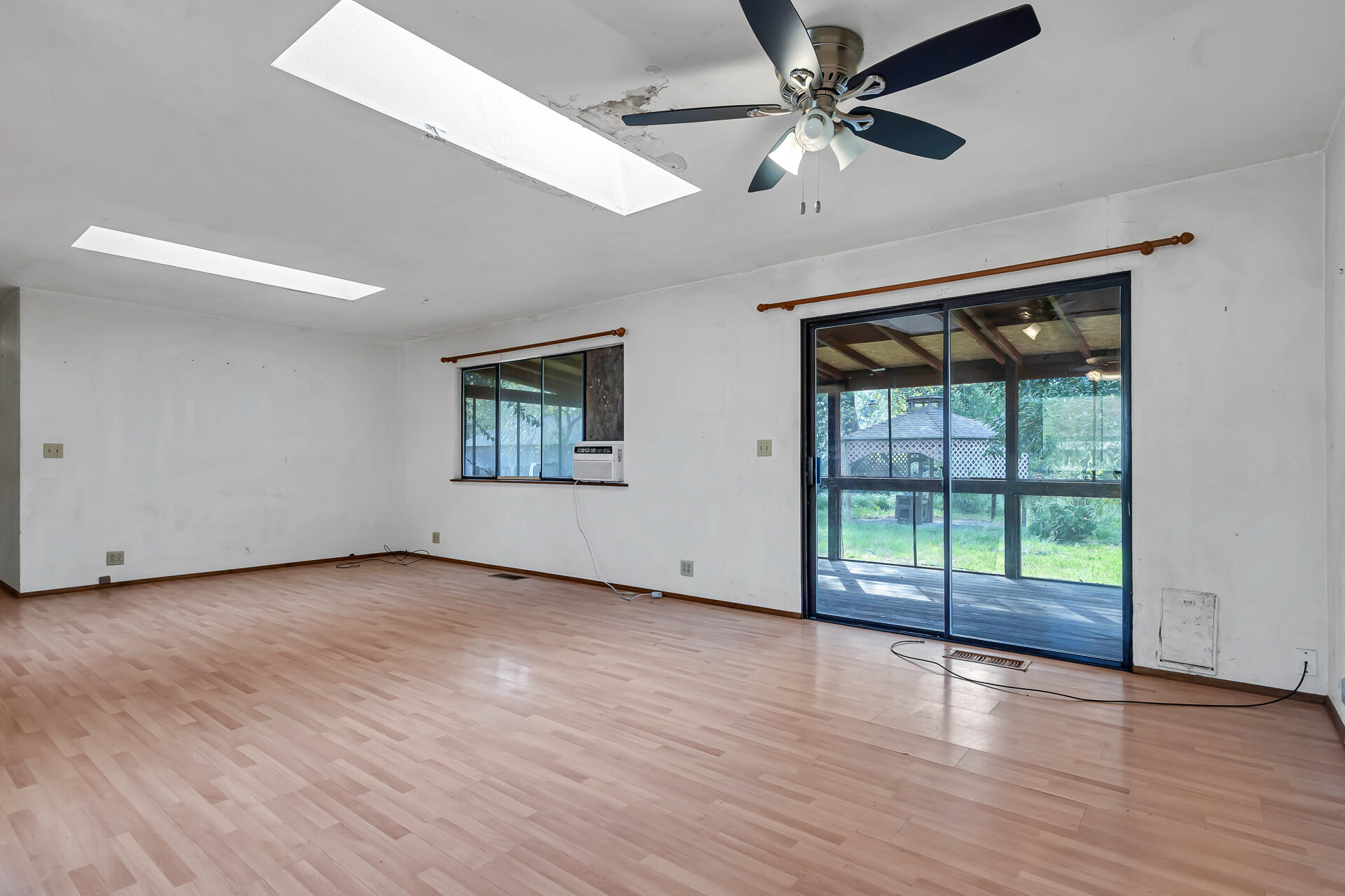 240 D Street Tehama, CA 96090 - Photo 10 of 41 an empty room with wooden floor and windows