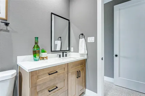 a bathroom with a sink vanity and a mirror