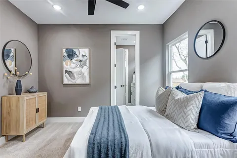 a bedroom with a large bed and a chandelier