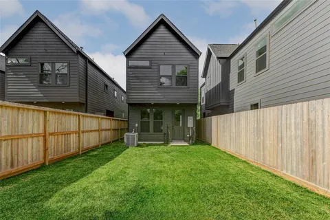 a view of a house with wooden fence