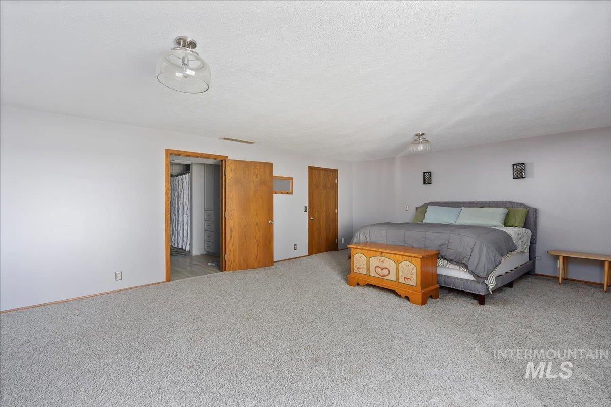 173 Main Line Ranch Road Rupert, ID 83350 - Photo 30 of 47 Carpeted bedroom with baseboards and a textured ceiling