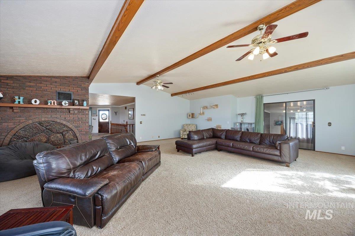 173 Main Line Ranch Road Rupert, ID 83350 - Photo 4 of 47 Carpeted living area with a ceiling fan and a brick fireplace