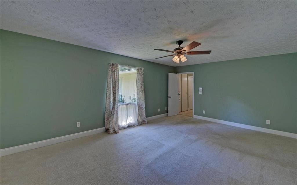1858 Pinecrest Road Gainesville, GA 30501 - Photo 28 of 55 an empty room and chandelier fan