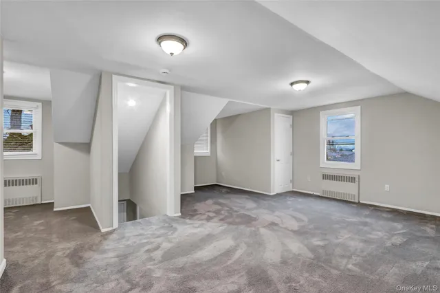 an empty room with closet and windows