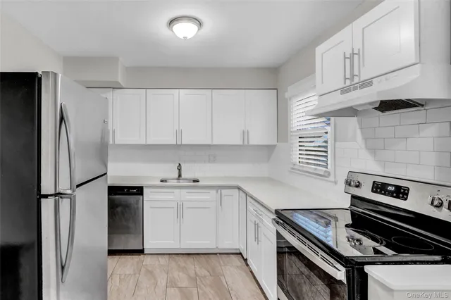 a kitchen with a stove sink and refrigerator