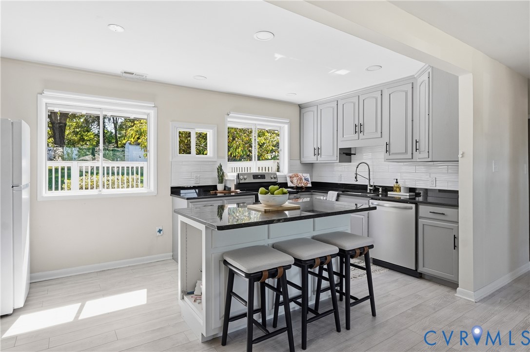 9207 Mapleway Road Richmond, VA 23229 - Photo 10 of 36 Kitchen featuring a central island, light gray cab