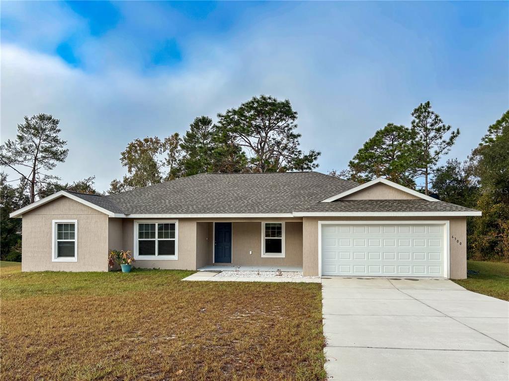 6300 Southwest 144th Lane Road Ocala, FL 34473 - Photo 1 of 1 a front view of a house with a garden
