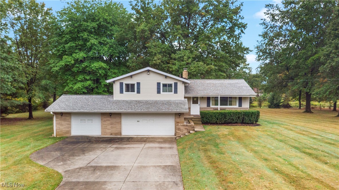 648 Rehwinkle Road Northfield, OH 44067 - Photo 1 of 38 Split level home featuring roof with shingles, brick siding, a garage, and concrete driveway