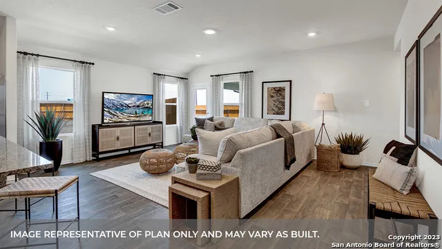 a living room with furniture fireplace and a flat screen tv