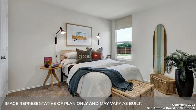 a bedroom with a bed a couch and a potted plant