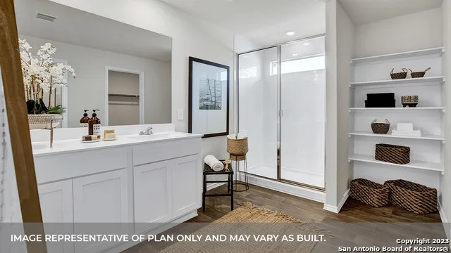 a bathroom with a toilet and a potted plant