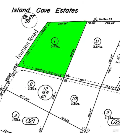 a view of a park with furniture and a sign