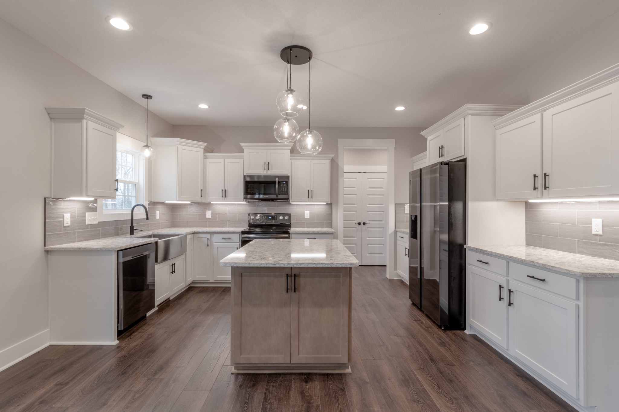 600 Swift Lane Cunningham, TN 37052 - Photo 11 of 38 a kitchen with refrigerator a sink and wooden floor