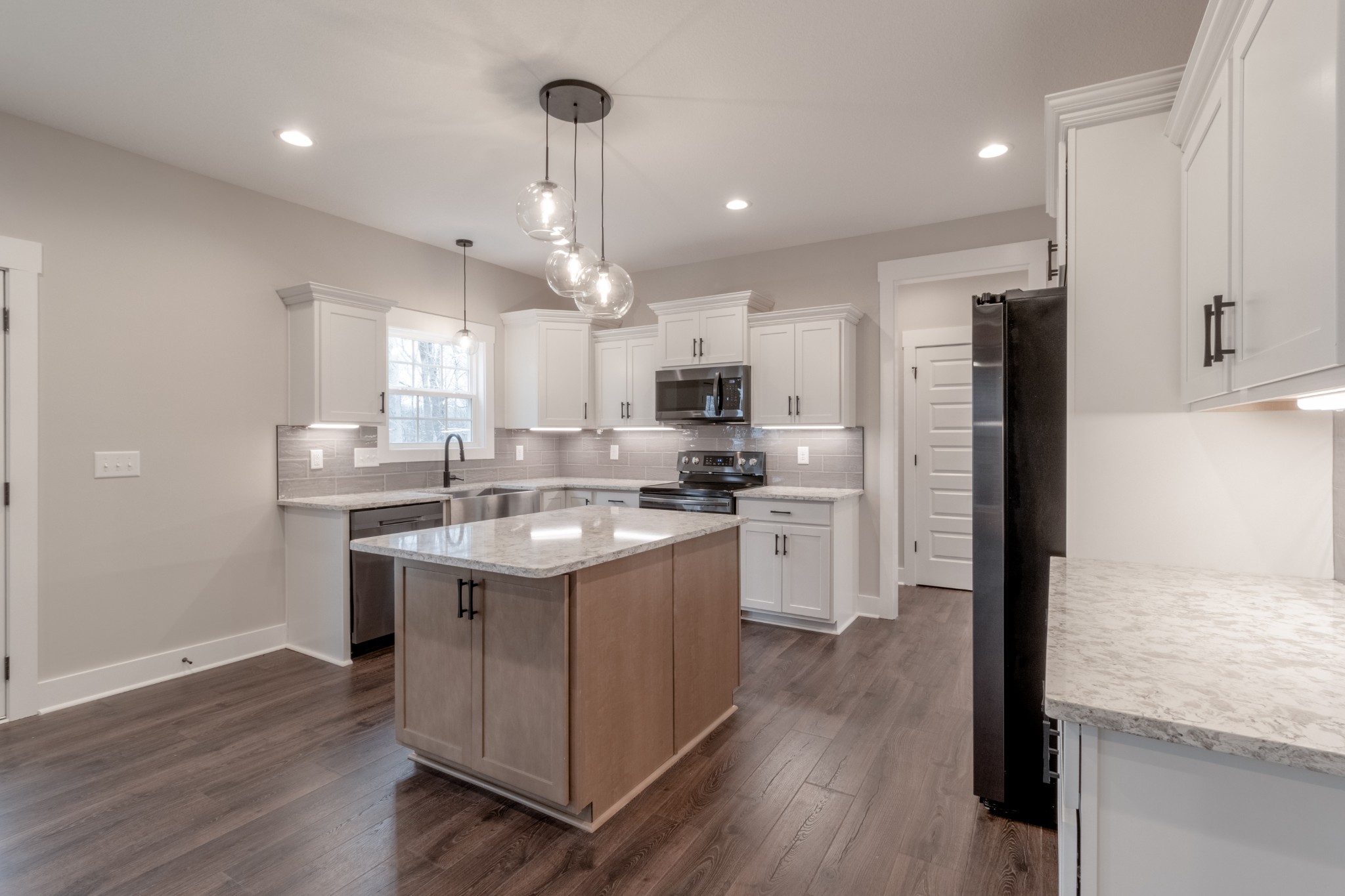 600 Swift Lane Cunningham, TN 37052 - Photo 12 of 38 a kitchen with stainless steel appliances granite countertop a sink stove and refrigerator
