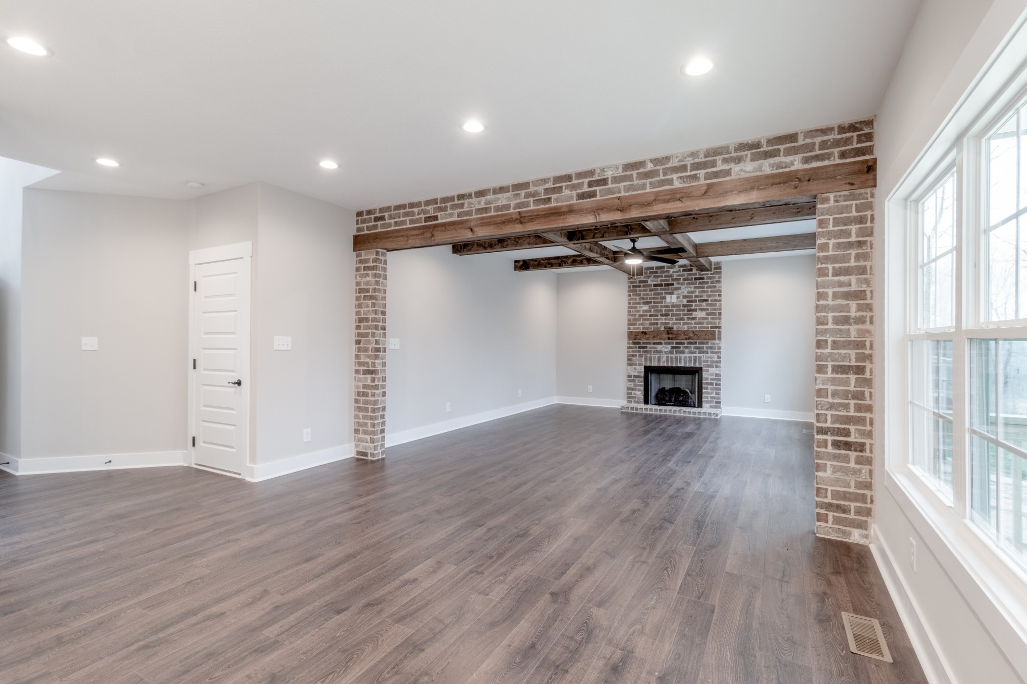 600 Swift Lane Cunningham, TN 37052 - Photo 9 of 38 an empty room with wooden floor and windows