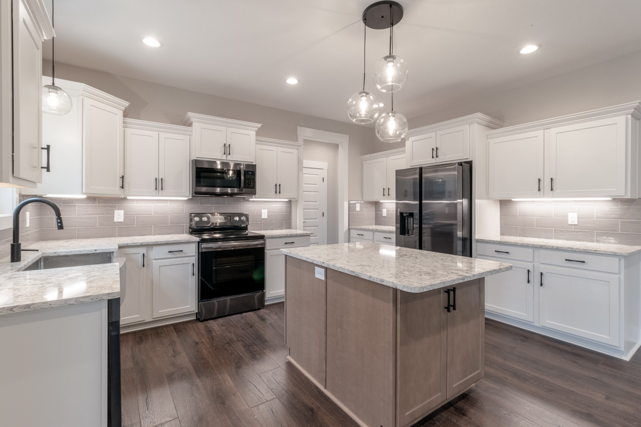 600 Swift Lane Cunningham, TN 37052 - Photo 10 of 38 a kitchen with stainless steel appliances granite countertop a stove refrigerator sink and microwave