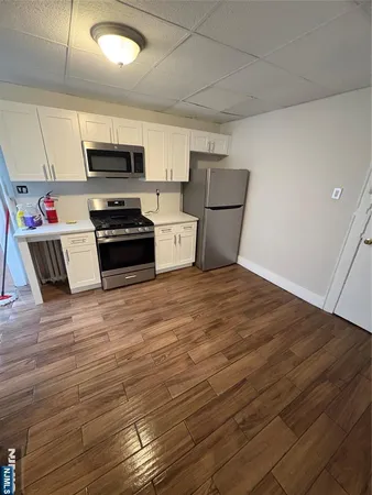 a kitchen with stainless steel appliances a refrigerator and a stove top oven