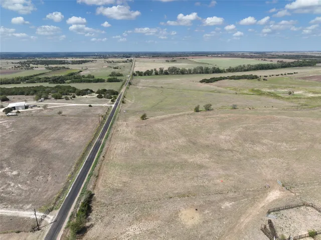 a view of dirt field with beach
