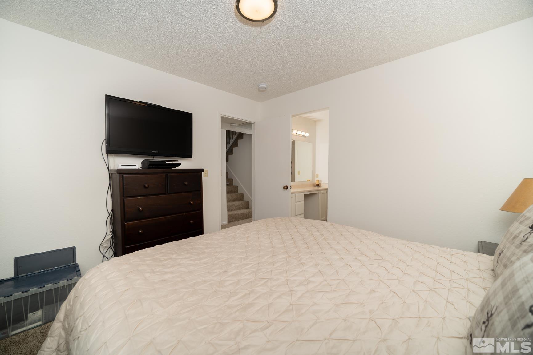 3460 Bowie Road Reno, NV 89503 - Photo 12 of 20 a bedroom with a bed and a flat screen tv