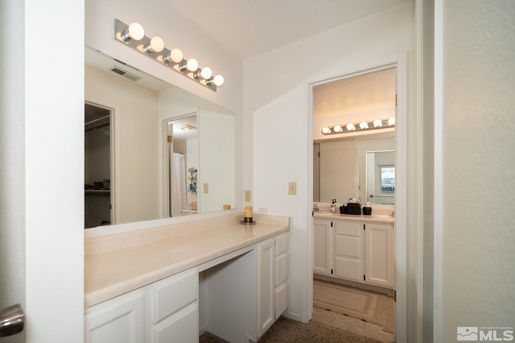 3460 Bowie Road Reno, NV 89503 - Photo 13 of 20 a bathroom with a sink a light fixture and a mirror