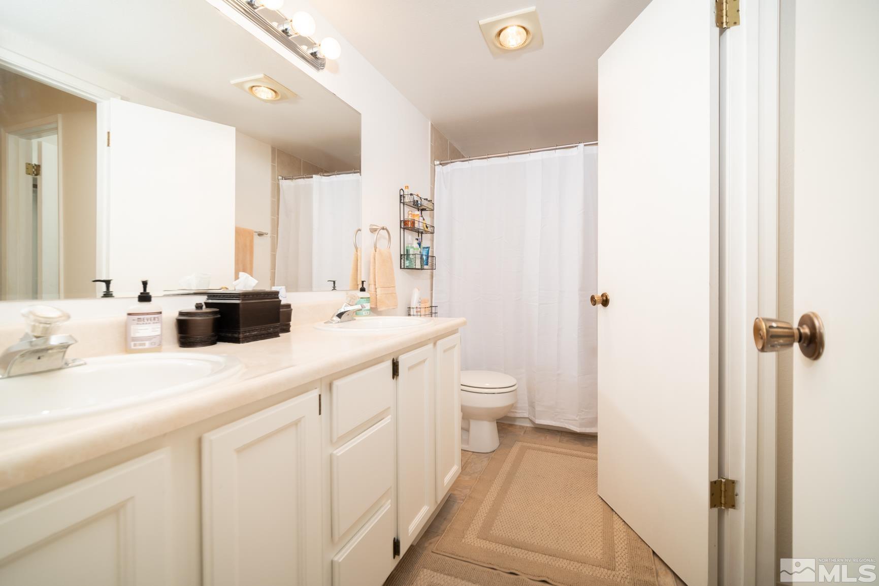 3460 Bowie Road Reno, NV 89503 - Photo 16 of 20 a bathroom with a sink a toilet and a shower