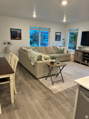 673 West 1920 South, Unit 1063 Provo, UT 84601 - Photo 4 of 15 Open-concept living area featuring wood-finish flooring, recessed ceiling lighting, and multiple windows