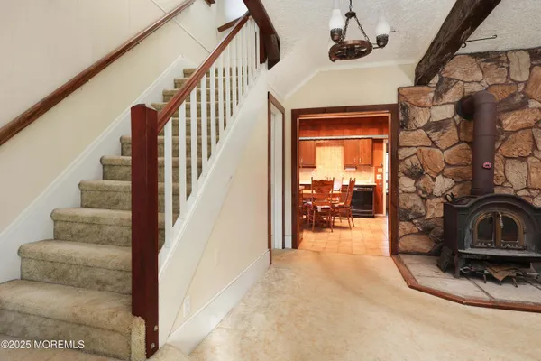 a view of a livingroom with furniture and staircase