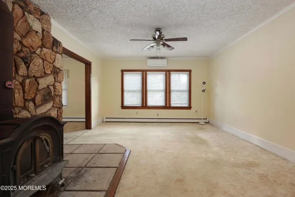 a view of a livingroom with a stove and chandelier wooden floor
