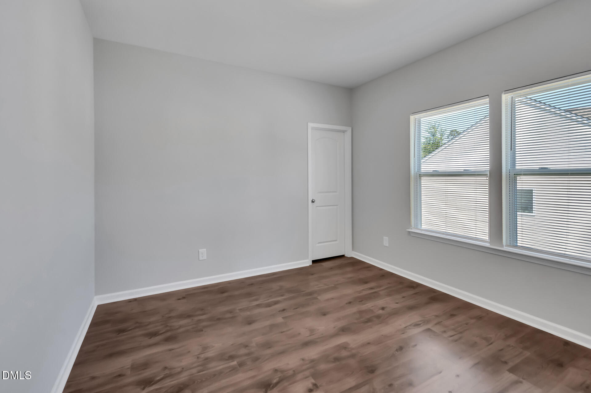 5406 Ripplebrook Drive Durham, NC 27712 - Photo 27 of 37 a view of an empty room with wooden floor and a window