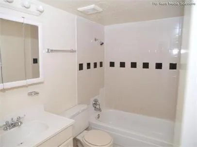 a white bath tub sitting next to a white toilet