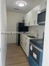 a kitchen with stainless steel appliances a stove a sink and a microwave