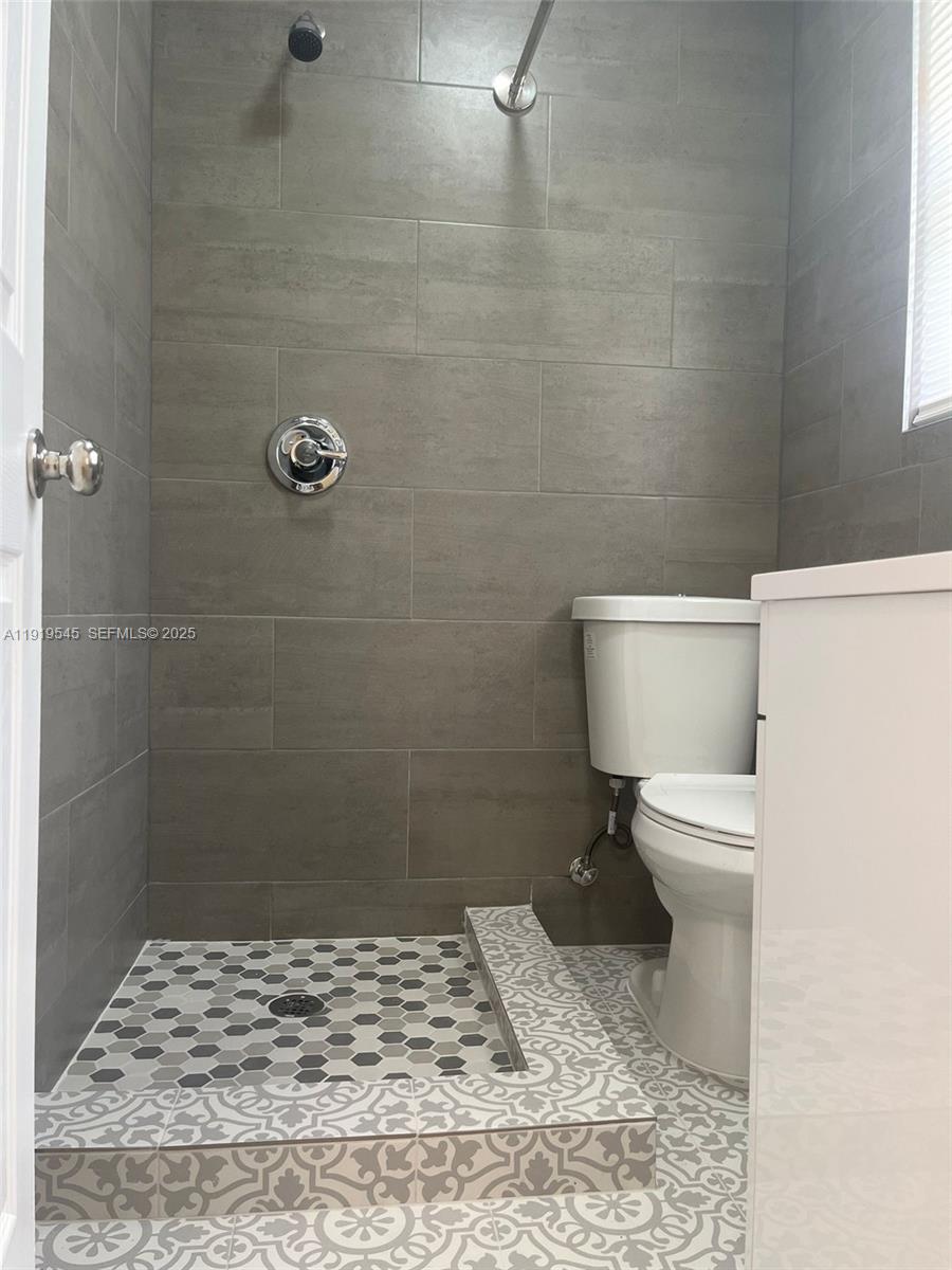 5808 Buchanan Street, Unit 3 Hollywood, FL 33021 - Photo 3 of 7 a bathroom with a toilet and a shower