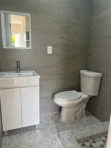 a white toilet sitting next to a bathroom sink