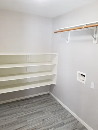 a view of walk in closet with empty racks