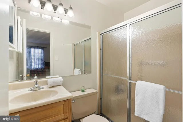a bathroom with a toilet a sink and a mirror