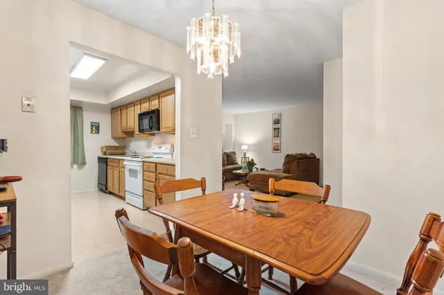a view of a dining room with furniture and a chandelier
