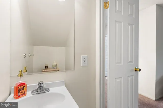 a spacious bedroom with a bed and a flat tv screen on a dresser