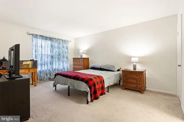 a bedroom with a bed and a television