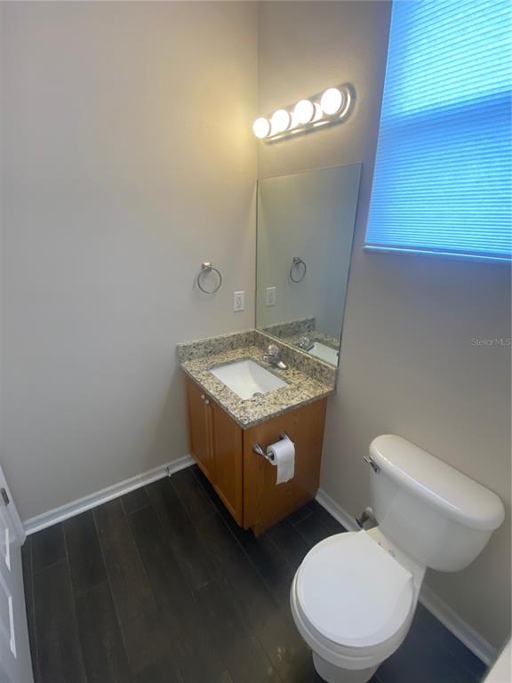 2409 Spring Hollow Loop Wesley Chapel, FL 33544 - Photo 11 of 47 a bathroom with a toilet sink and mirror