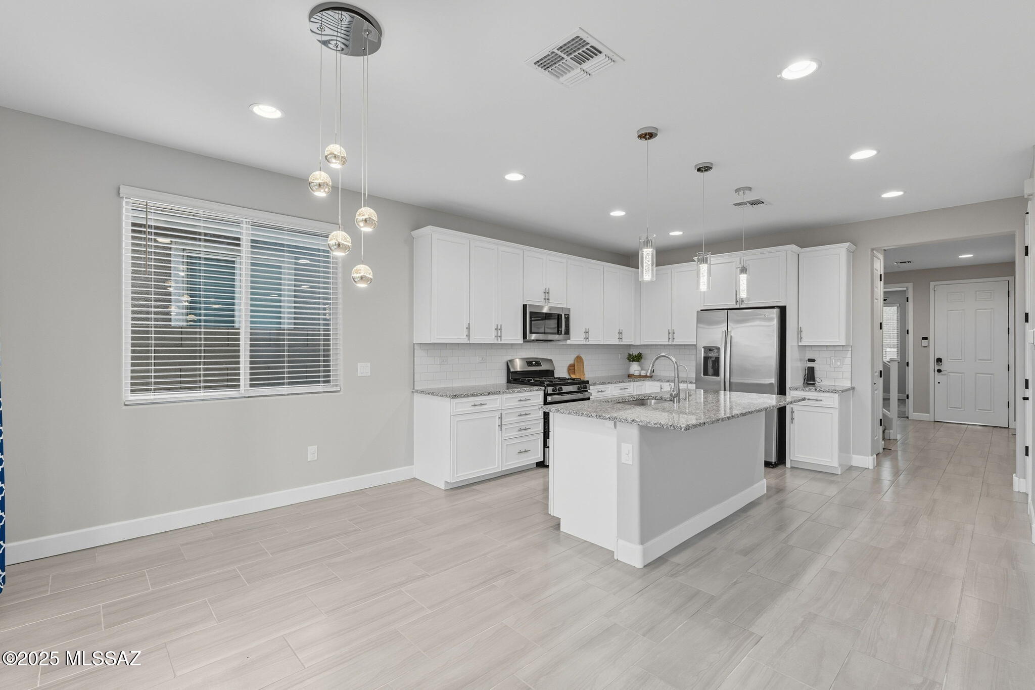 12100 East Ryscott Circle Vail, AZ 85641 - Photo 10 of 53 a kitchen with stainless steel appliances kitchen island sink and refrigerator
