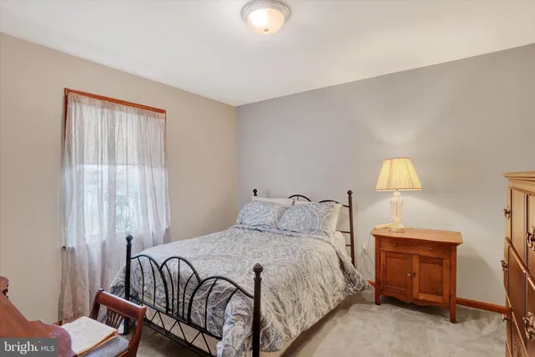 a bedroom with a bed and a lamp