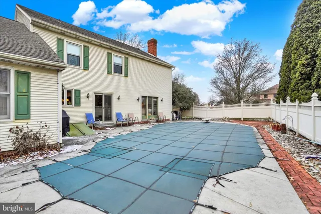 a view of a white house with a yard