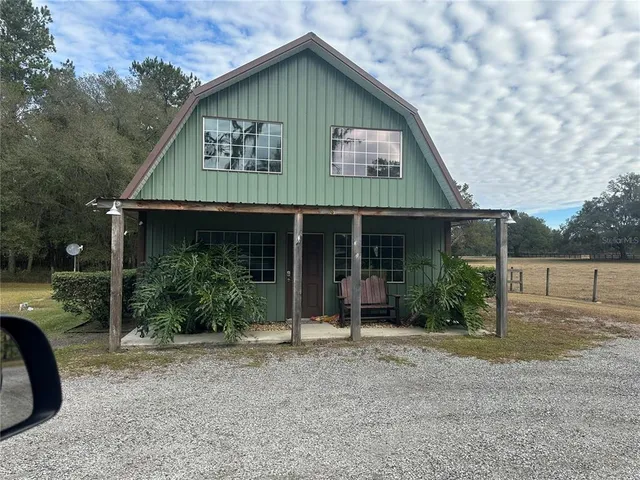 a view of house with backyard space and garden