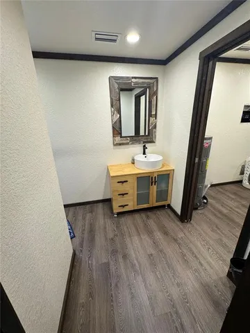 a view of a room with wooden floor and cabinet