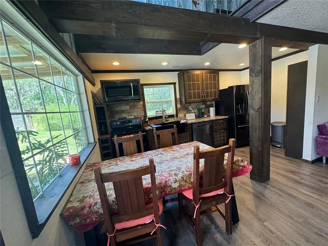 a outdoor dining space with furniture and wooden floor