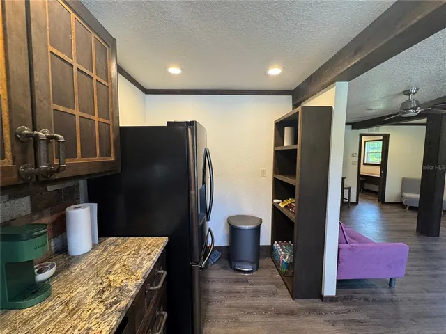 a kitchen with stainless steel appliances granite countertop refrigerator sink and cabinets