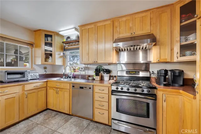 a kitchen with stainless steel appliances granite countertop a sink and cabinets