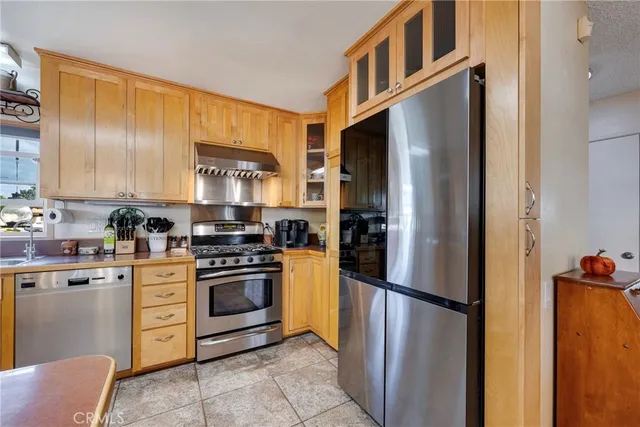 a kitchen with cabinets and refrigerator