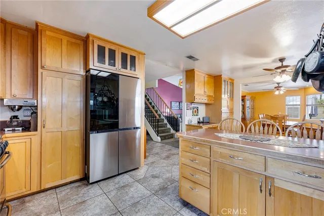 a large white kitchen with a large window and stainless steel appliances